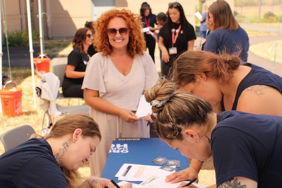 Patrizia Montanari with women completing First Step intake surveys at Coffee Creek Correctional Facility
