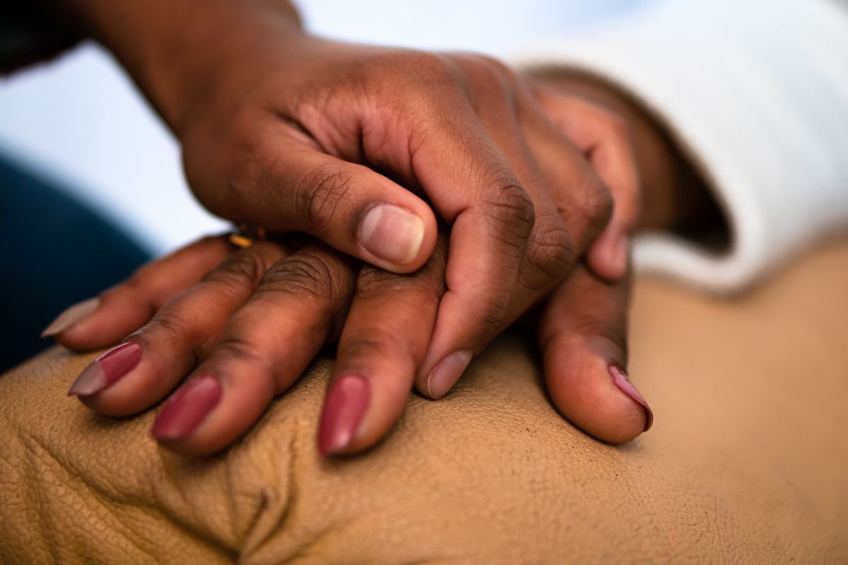 Two hands held in support