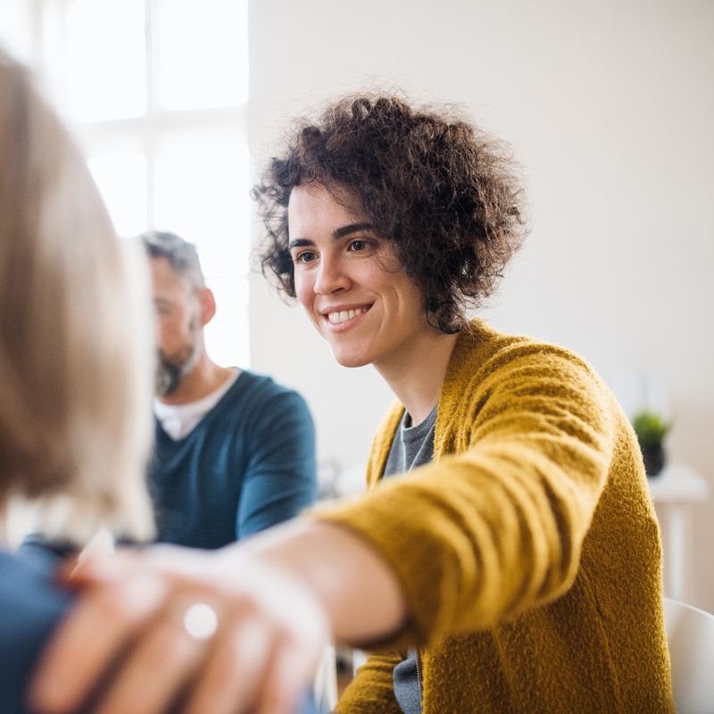 A mentor with her hand on a woman's shoulder