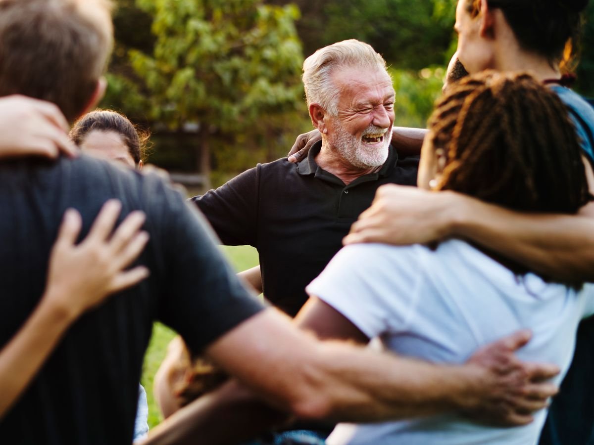 A group of people in a huddle, laughing